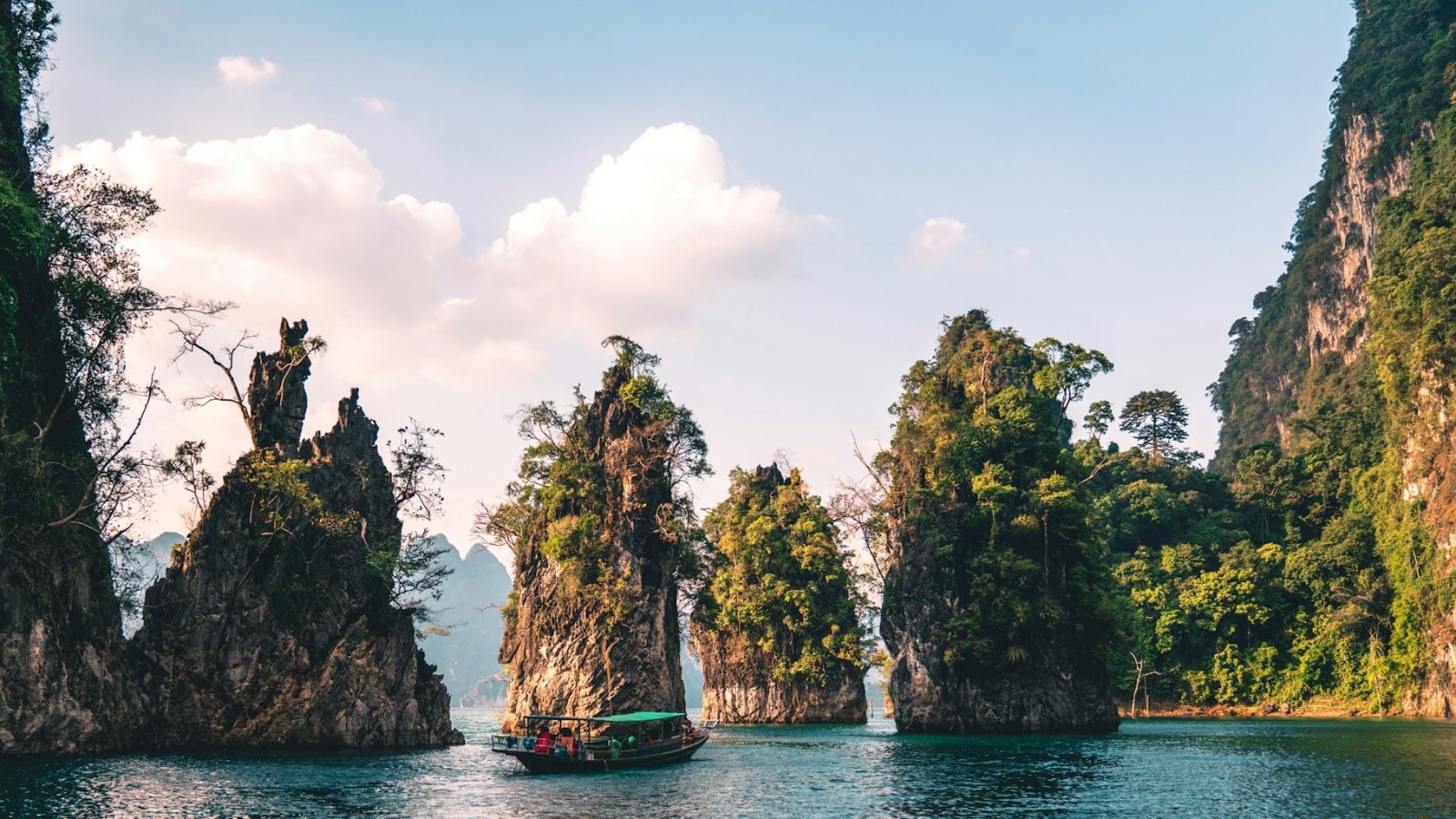 brown and white temple surrounded by green trees during daytime