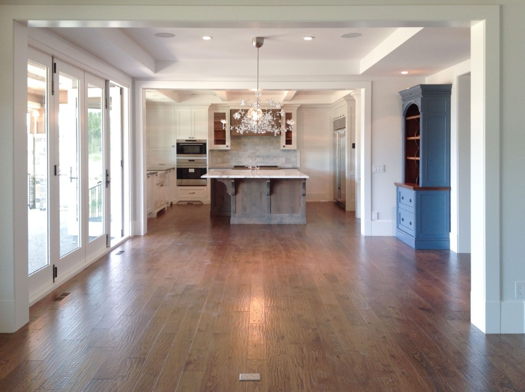 Image of Luxury kitchen and dining area with hardwood floors, island, and modern appliances by KHD Homes.