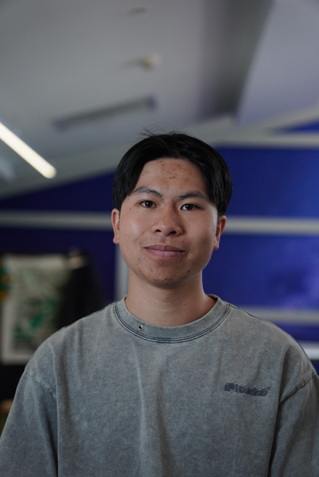 a man with a goatee smiles at the camera