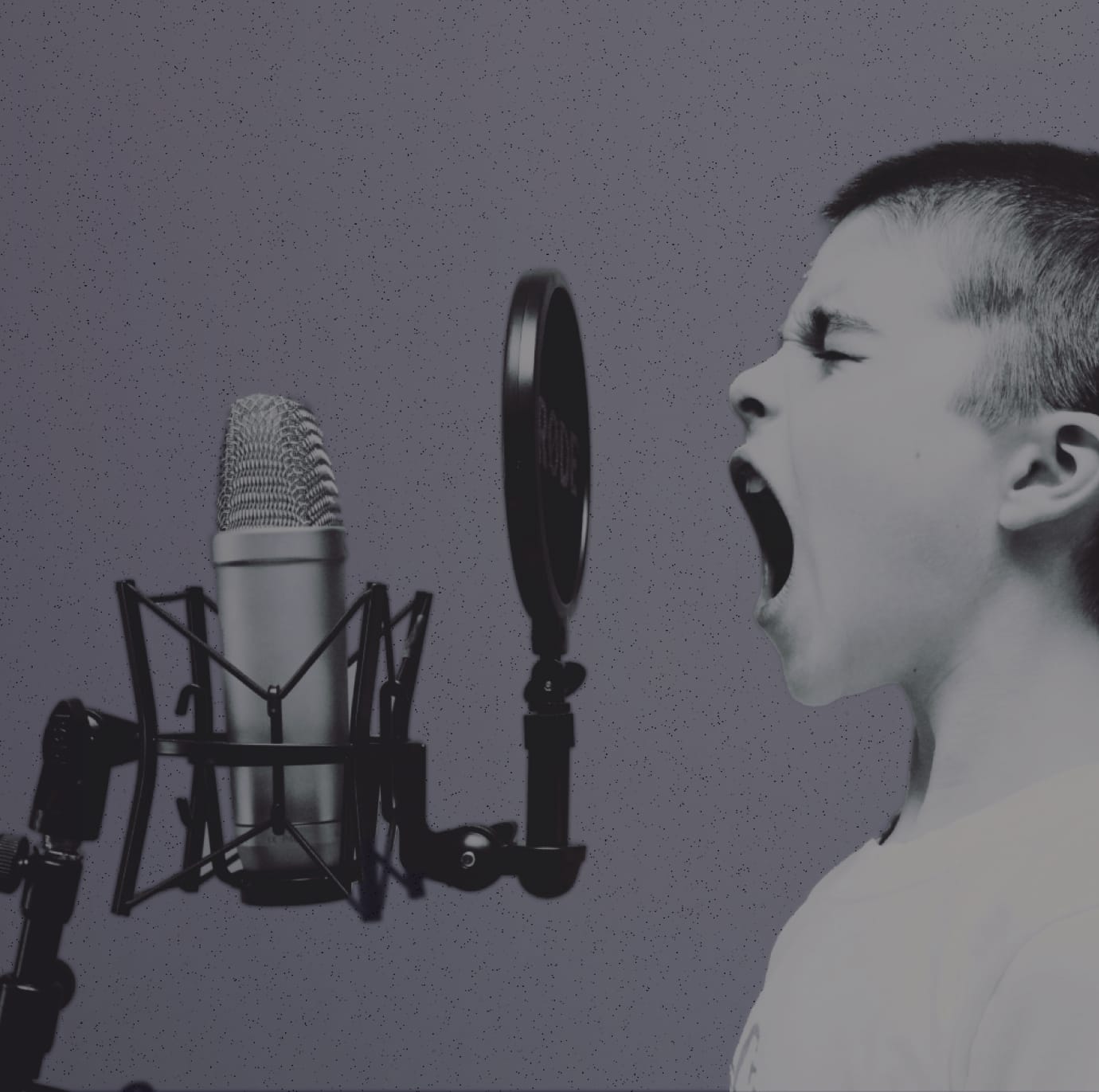 A photo of a young boy shouting into a microphone