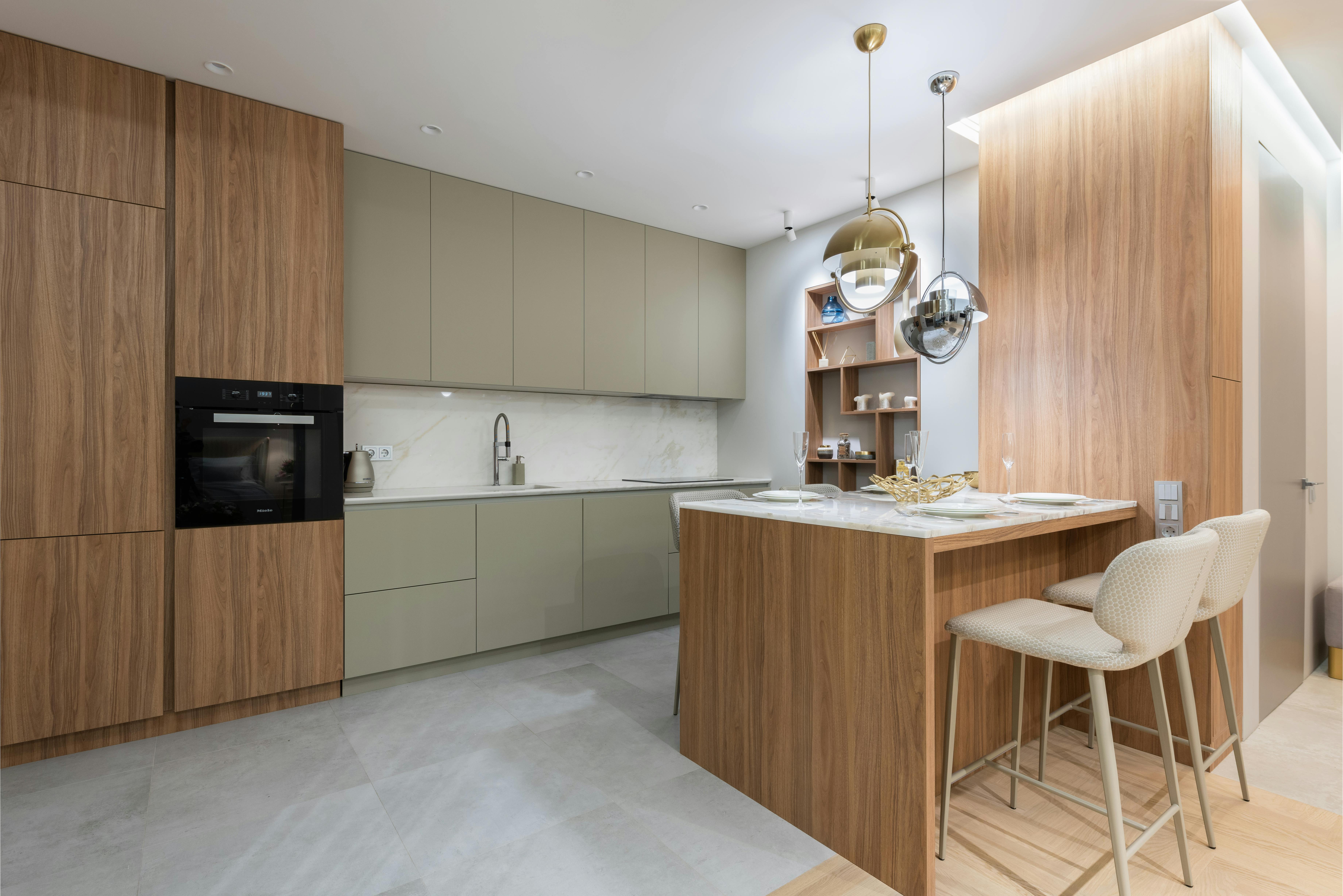 a kitchen with a refrigerator, stove, microwave and cabinets