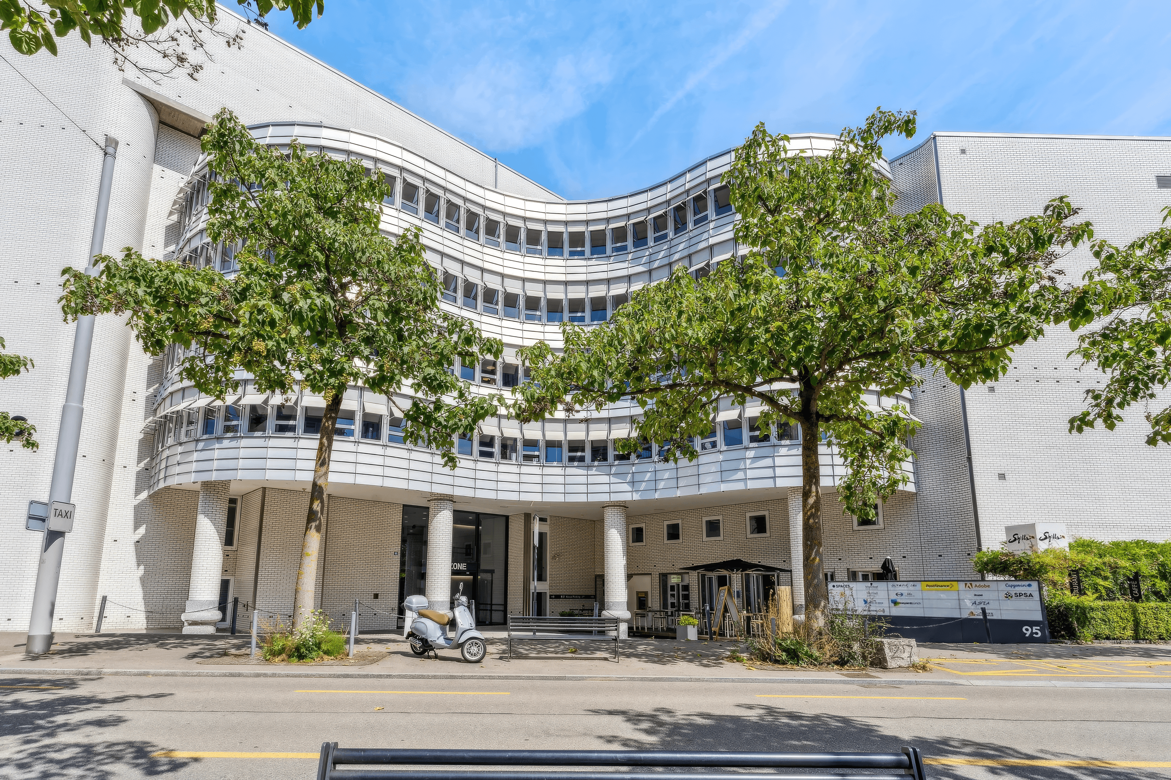 Modern tall building with a clear blue sky in Switzerland.