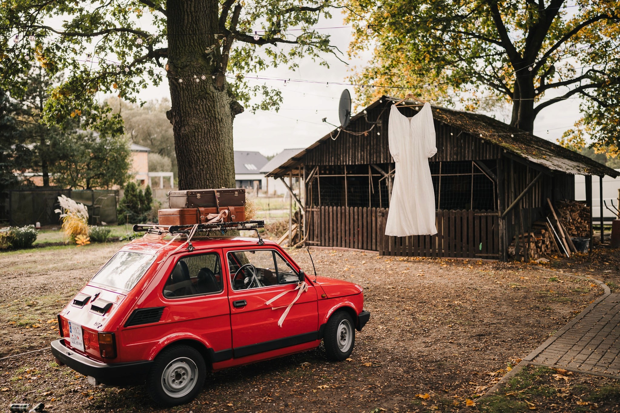 A couple joyfully celebrates in front of a rustic stone building.