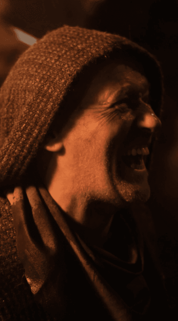 Dancer in black outfit with arms raised, arching backwards