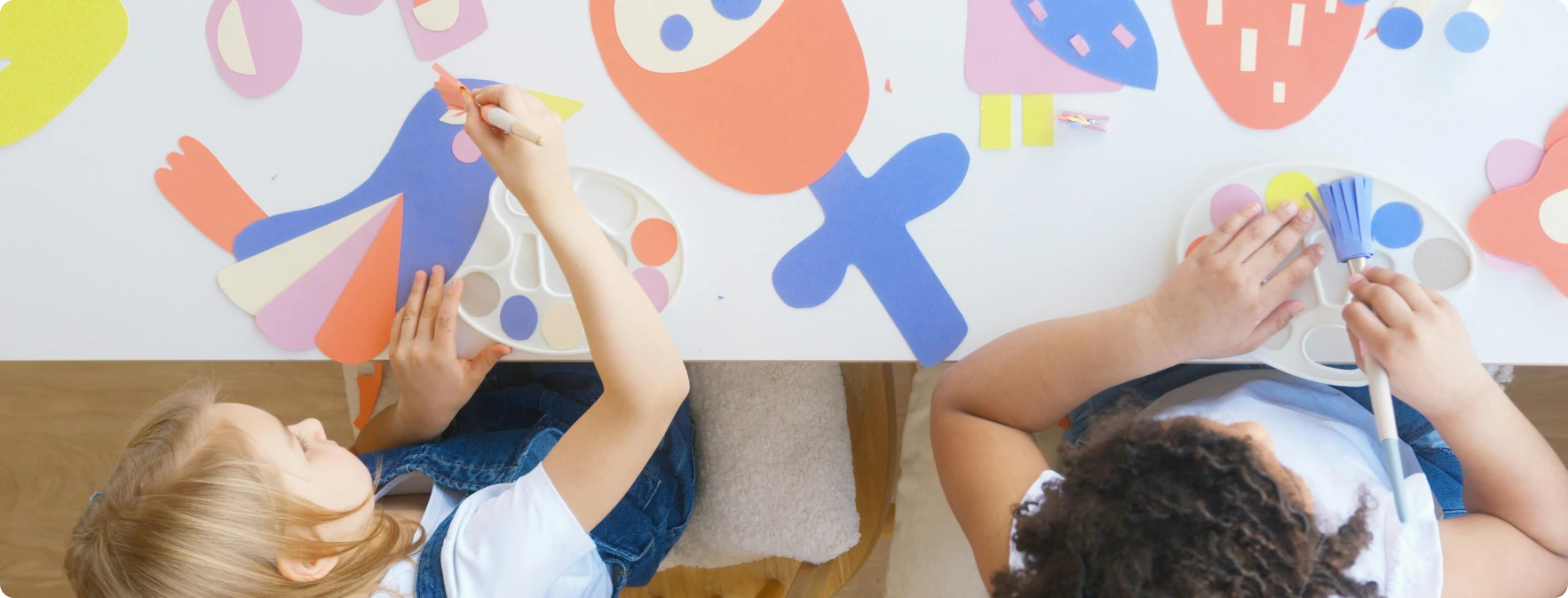 Children painting and cutting out pictures