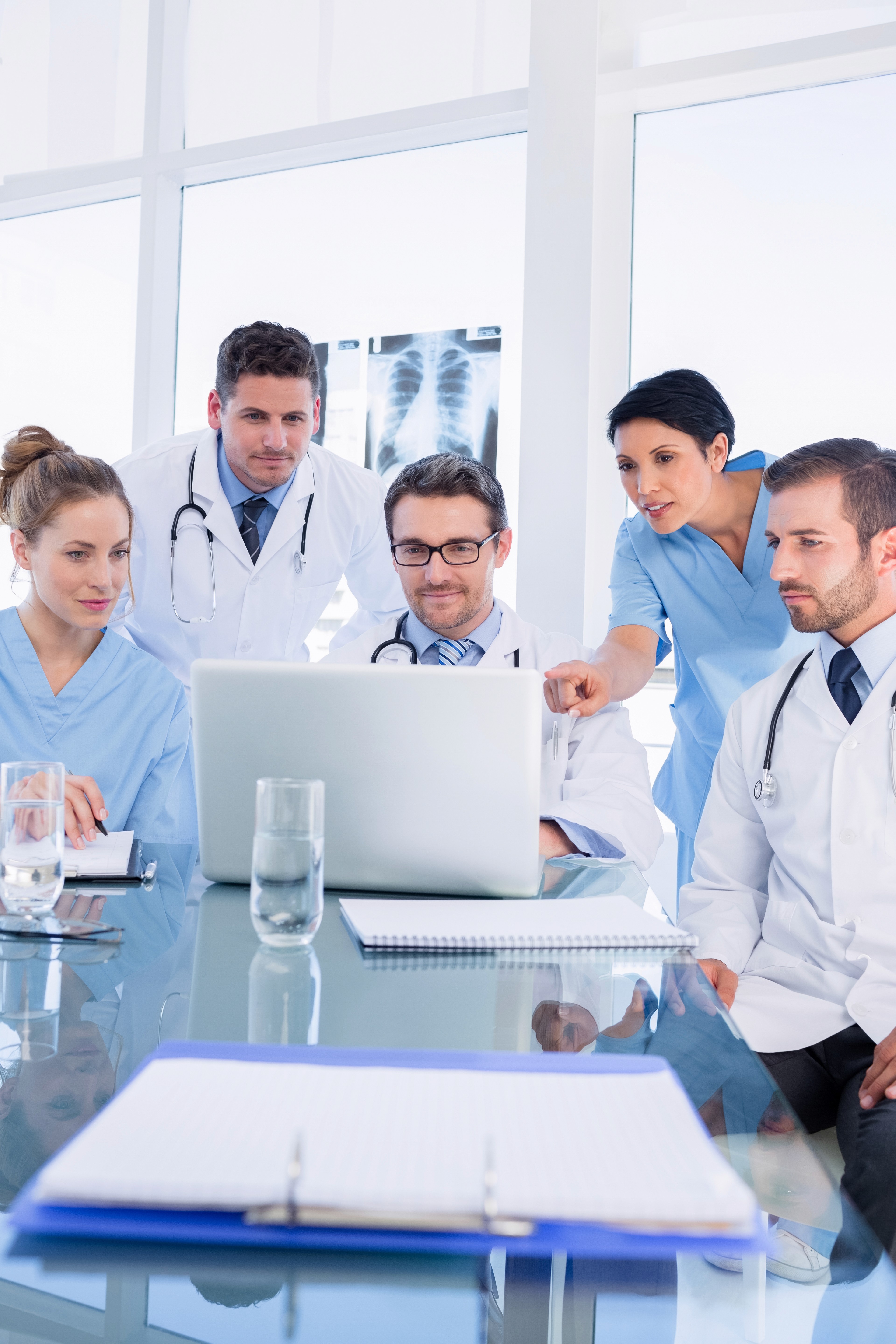 a woman in a doctor's coat talking to another woman