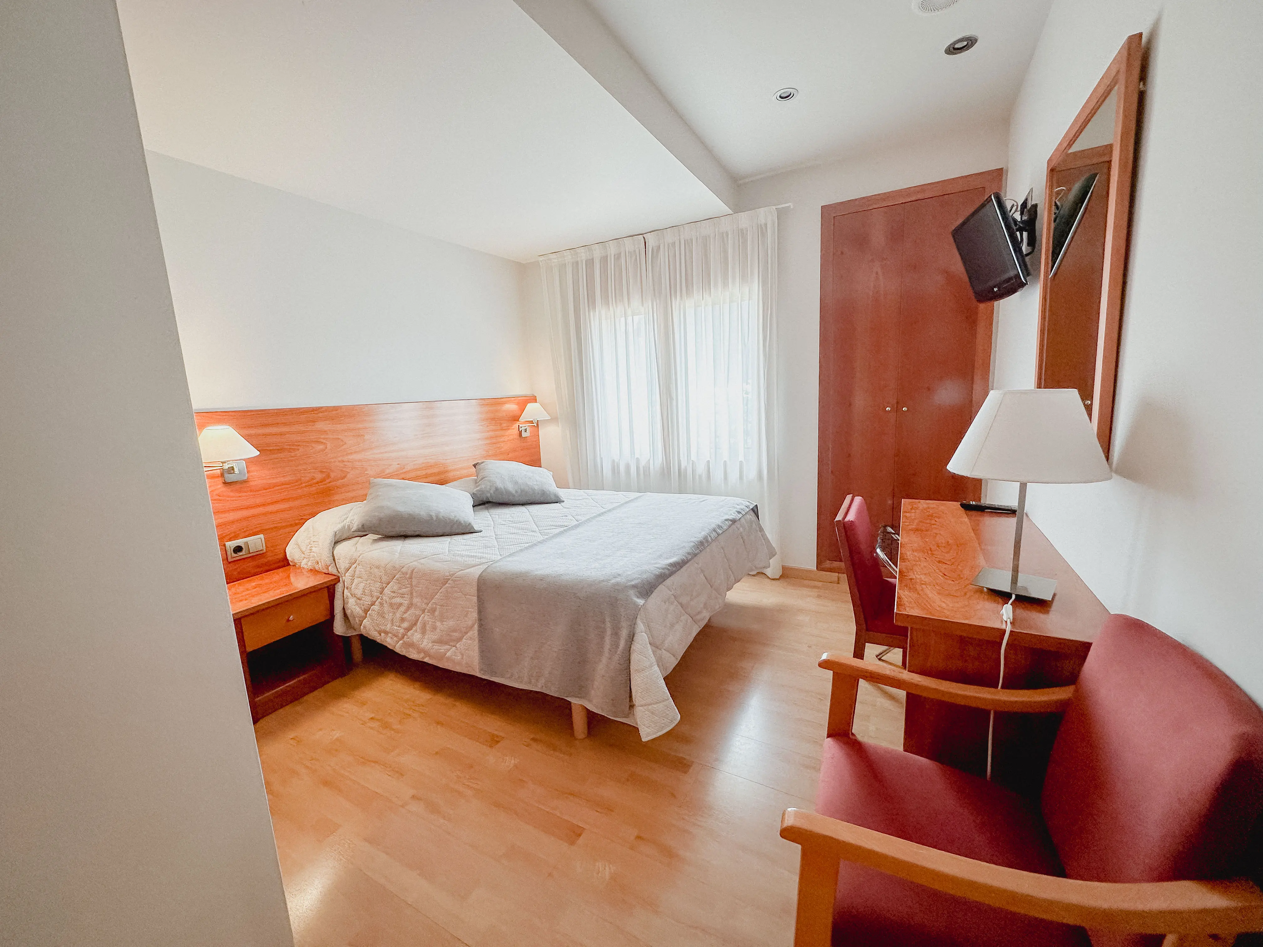 classy bedroom with white rooms, beige bed and blur grey duvet