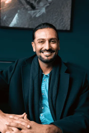 a dentist chair with a blue seat in a room