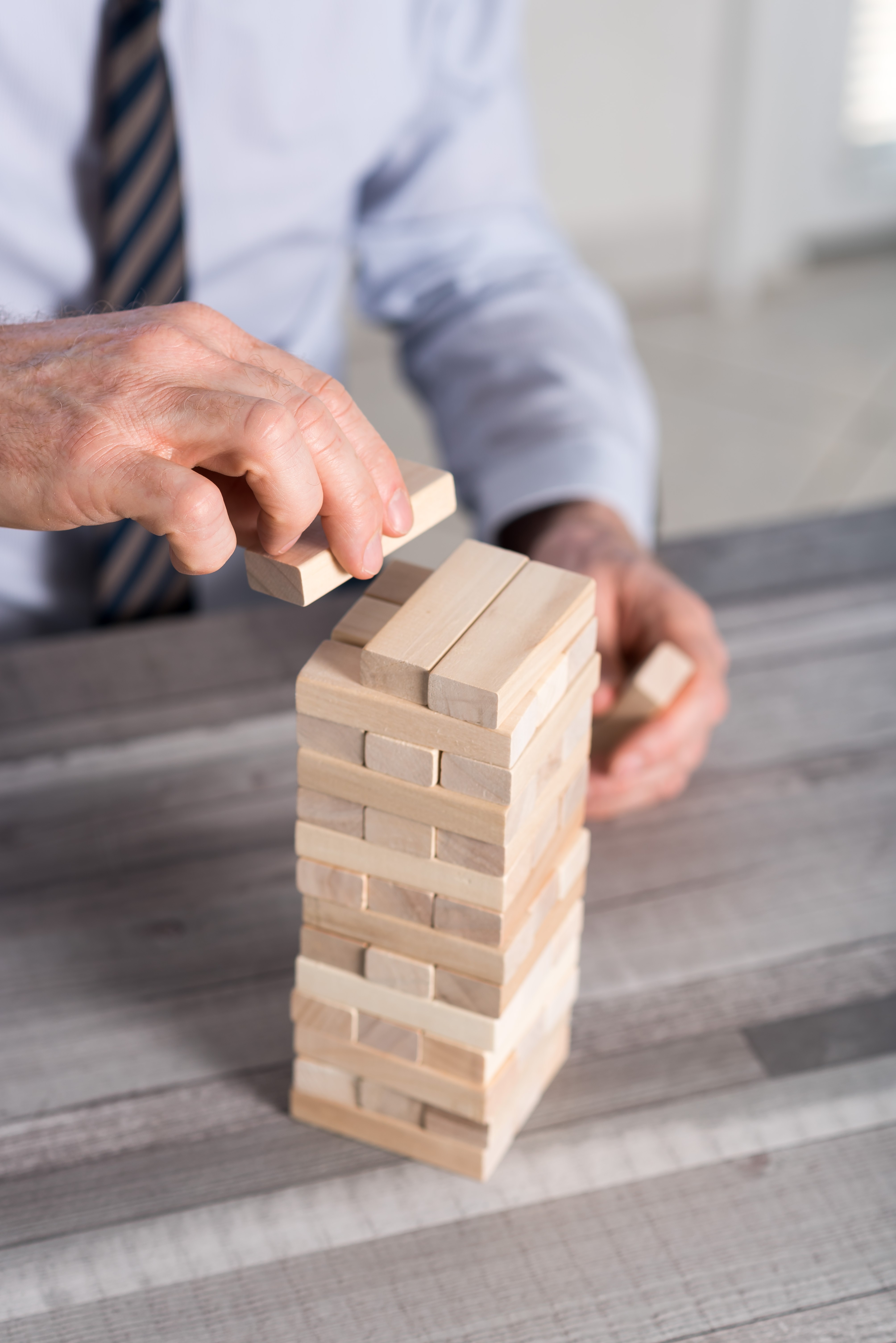 three men laughing while looking in the laptop inside room