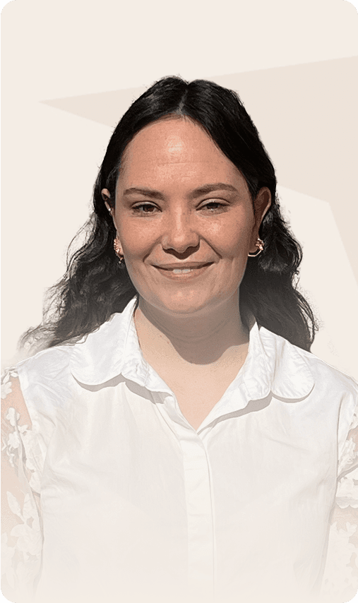 Portrait d'une femme portant une blouse blanche et souriant à la caméra.