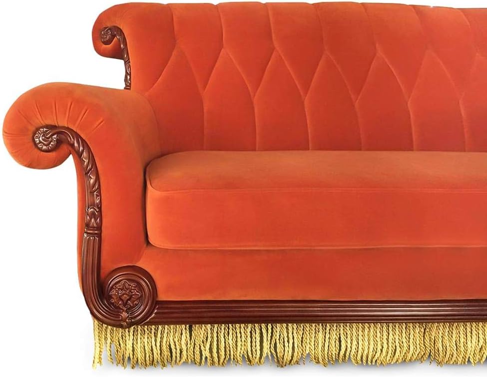 Cozy orange couch with soft cushions and a contemporary design, perfect for brightening any living room.