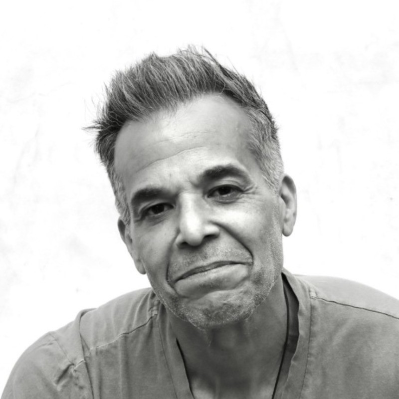 man in gray denim jacket wearing black framed eyeglasses