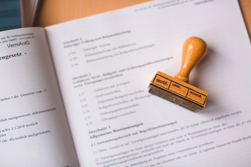 brown wooden hand tool on white printer paper illustrating the accommodation documents proof