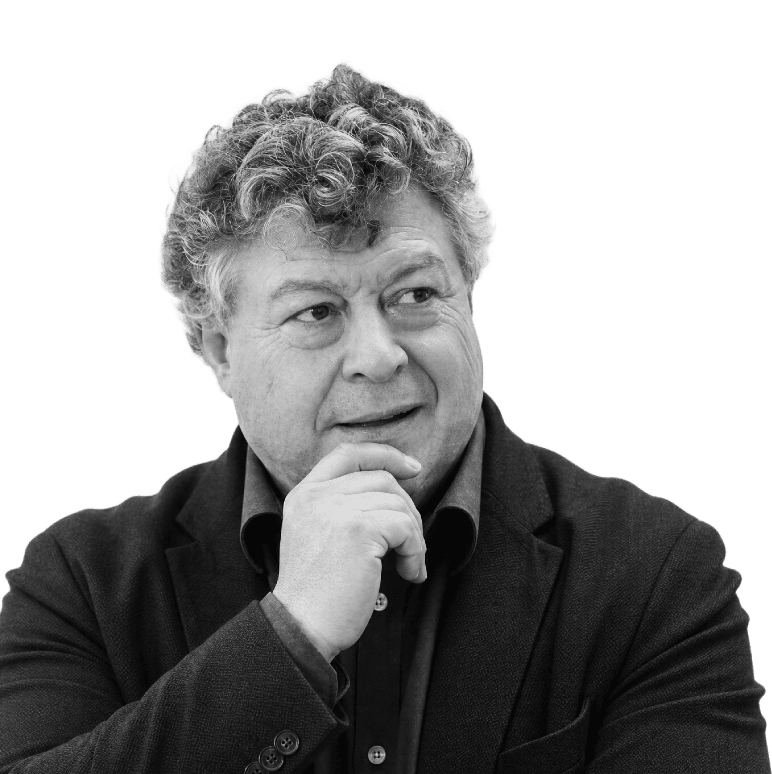 A studio headshot of a man wearing a suit in a thinking pose