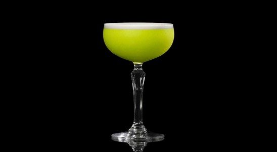 A closeup of a Irish Clover drink against a dark background.