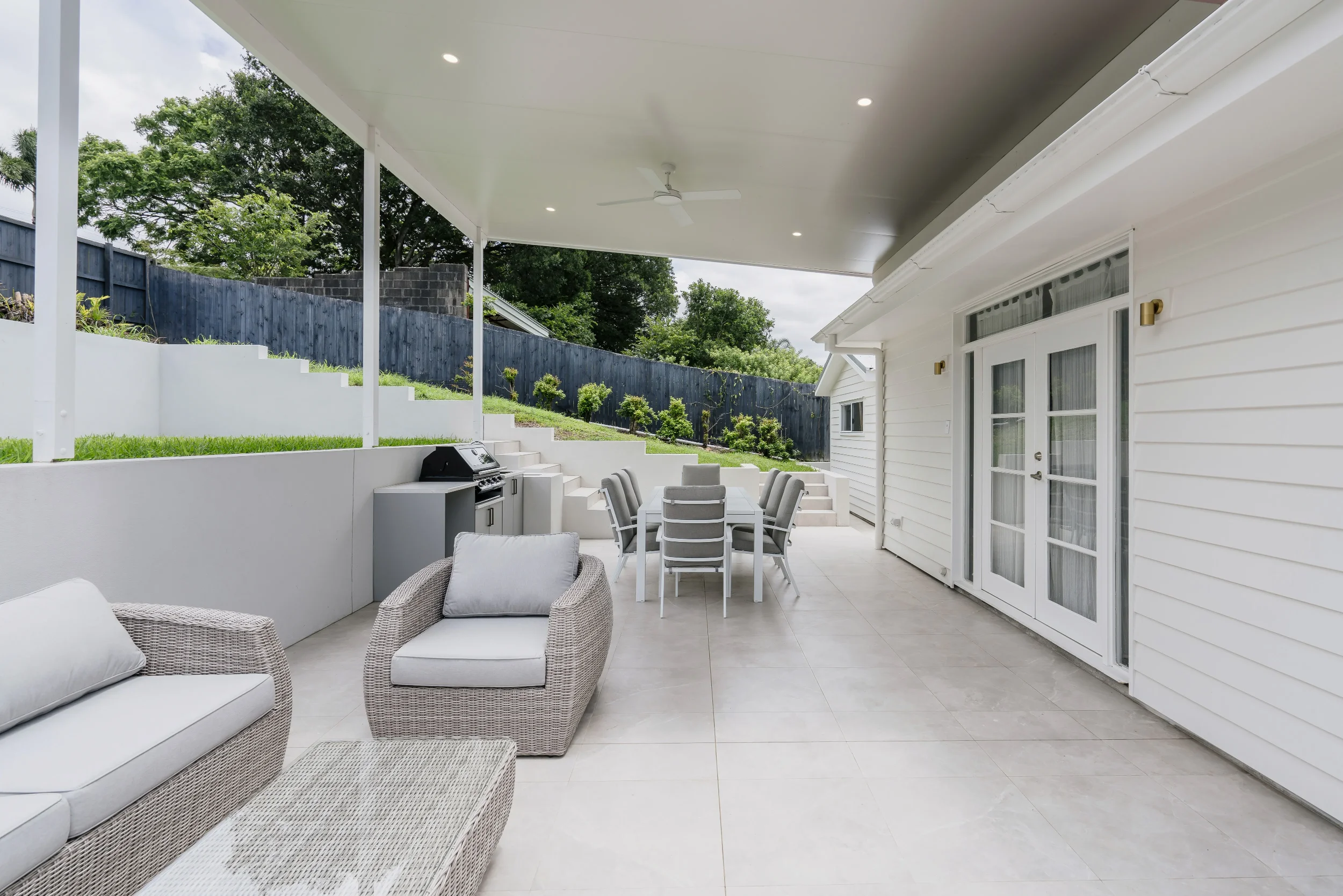 Home extension to a weatherboard house in New Farm, white gable addition