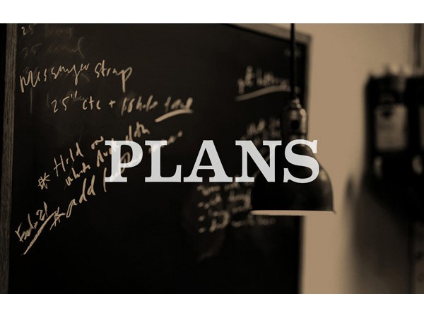 A blackboard displays handwritten notes in white chalk, including “Missy’s strip,” “25” cte + fshlte,” and “Hold on when Add.” A black pendant light hangs above the board. The word “PLANS” is superimposed in white capital letters across the center of the image.