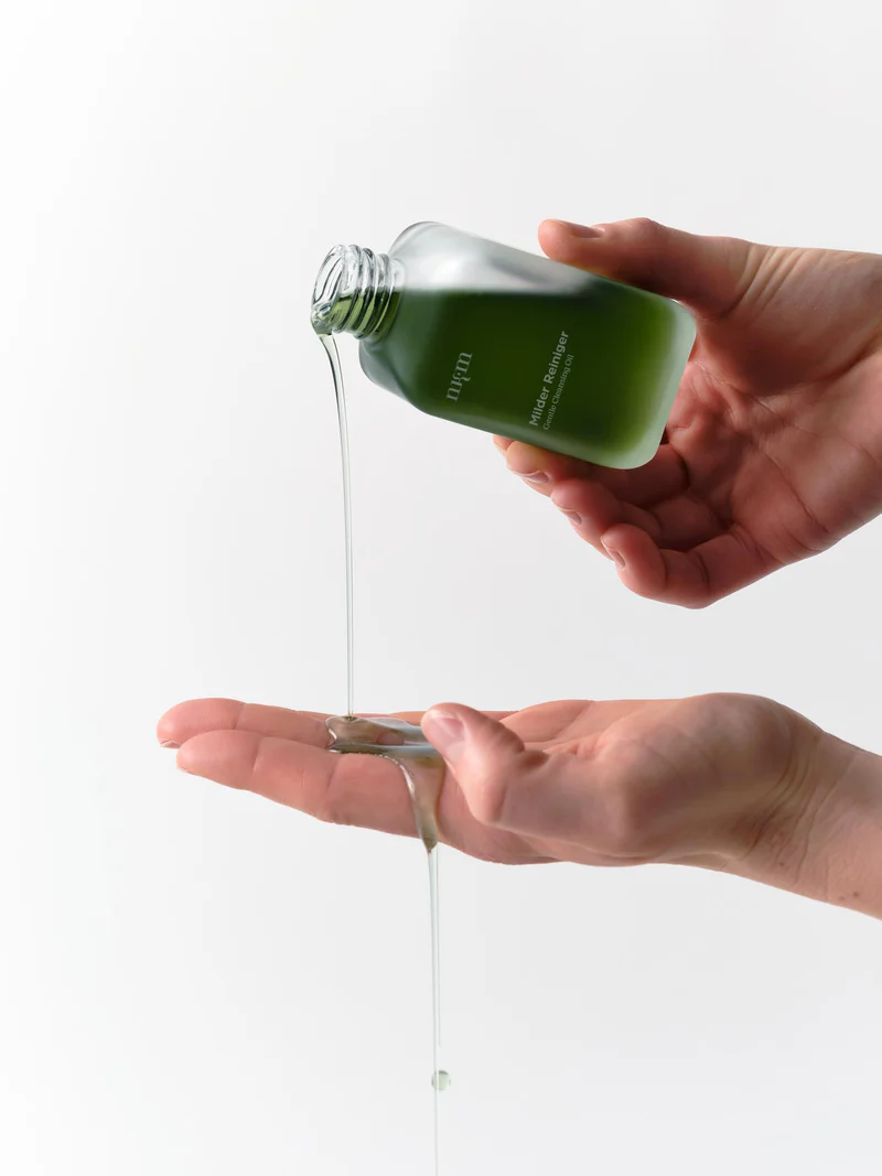 Oil being poured from bottle into hands