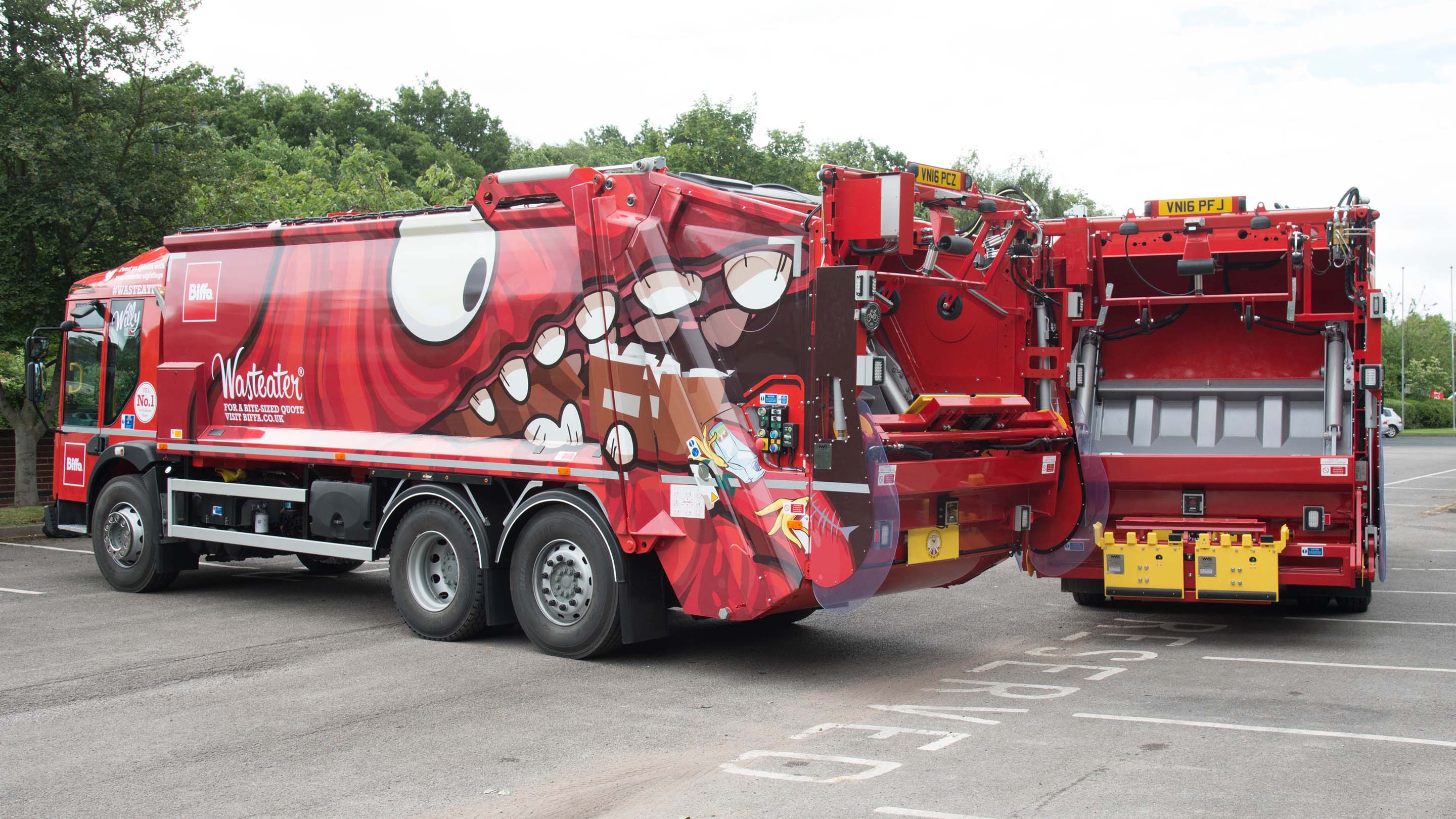 Two Biffa garbage trucks with a illustrator of a monster on the side