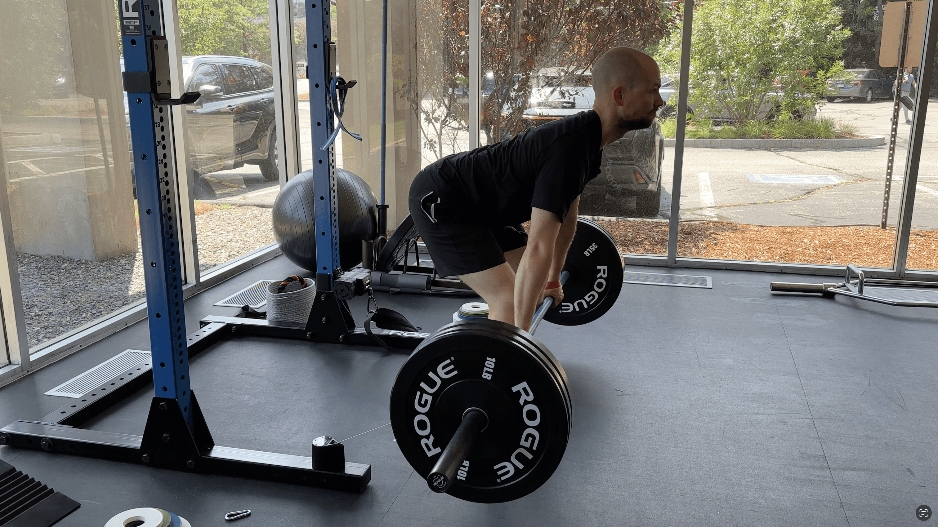 photo of man performing a deadlift in a training facility