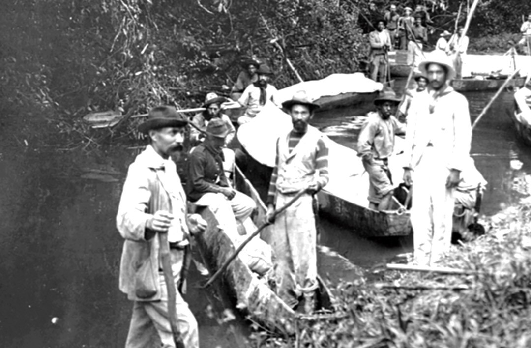 man in white button up shirt holding white smartphone