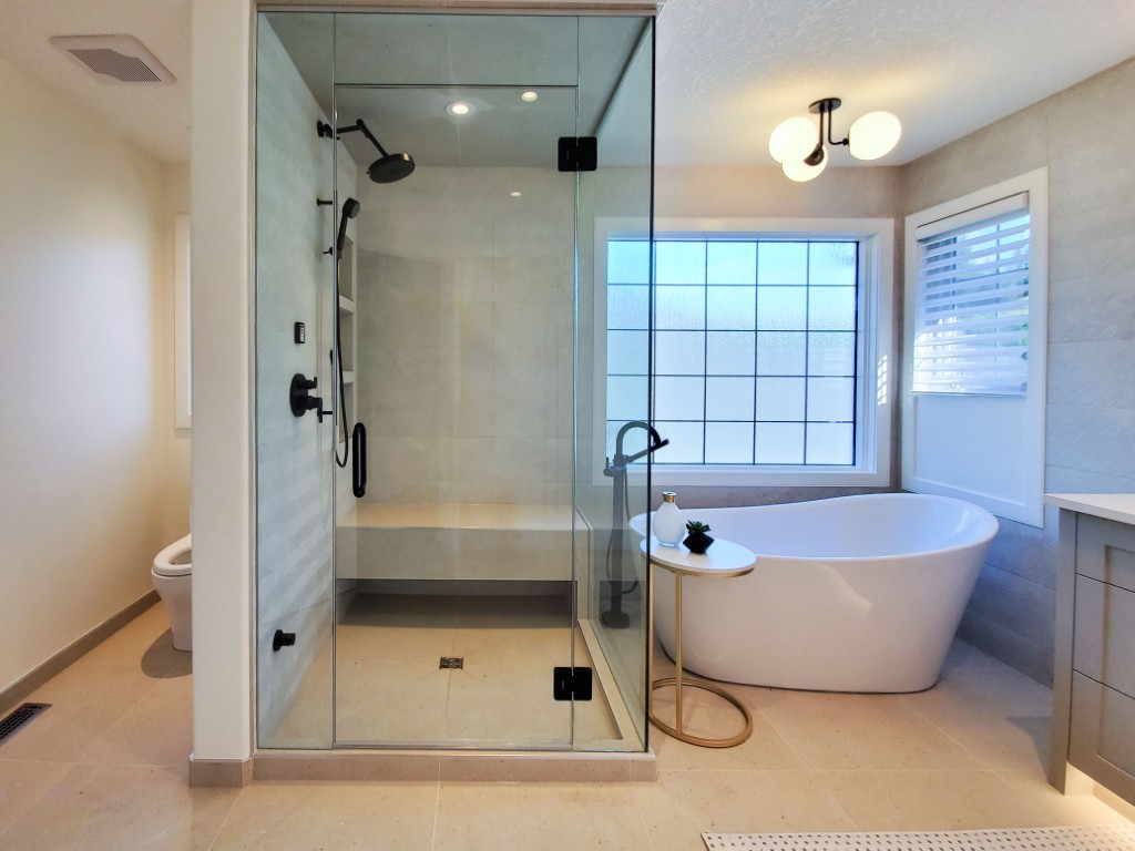 Image of Luxurious primary ensuite bathroom with modern glass shower, freestanding tub, and sleek design by KHD Homes.