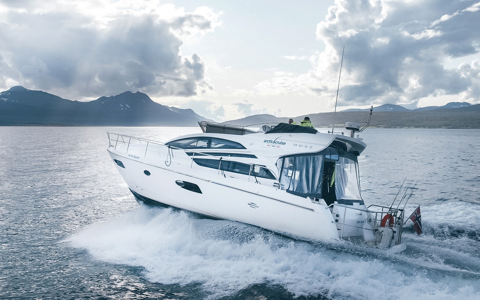 Boat cruising in Tromso fjord during silent whale watching tour.