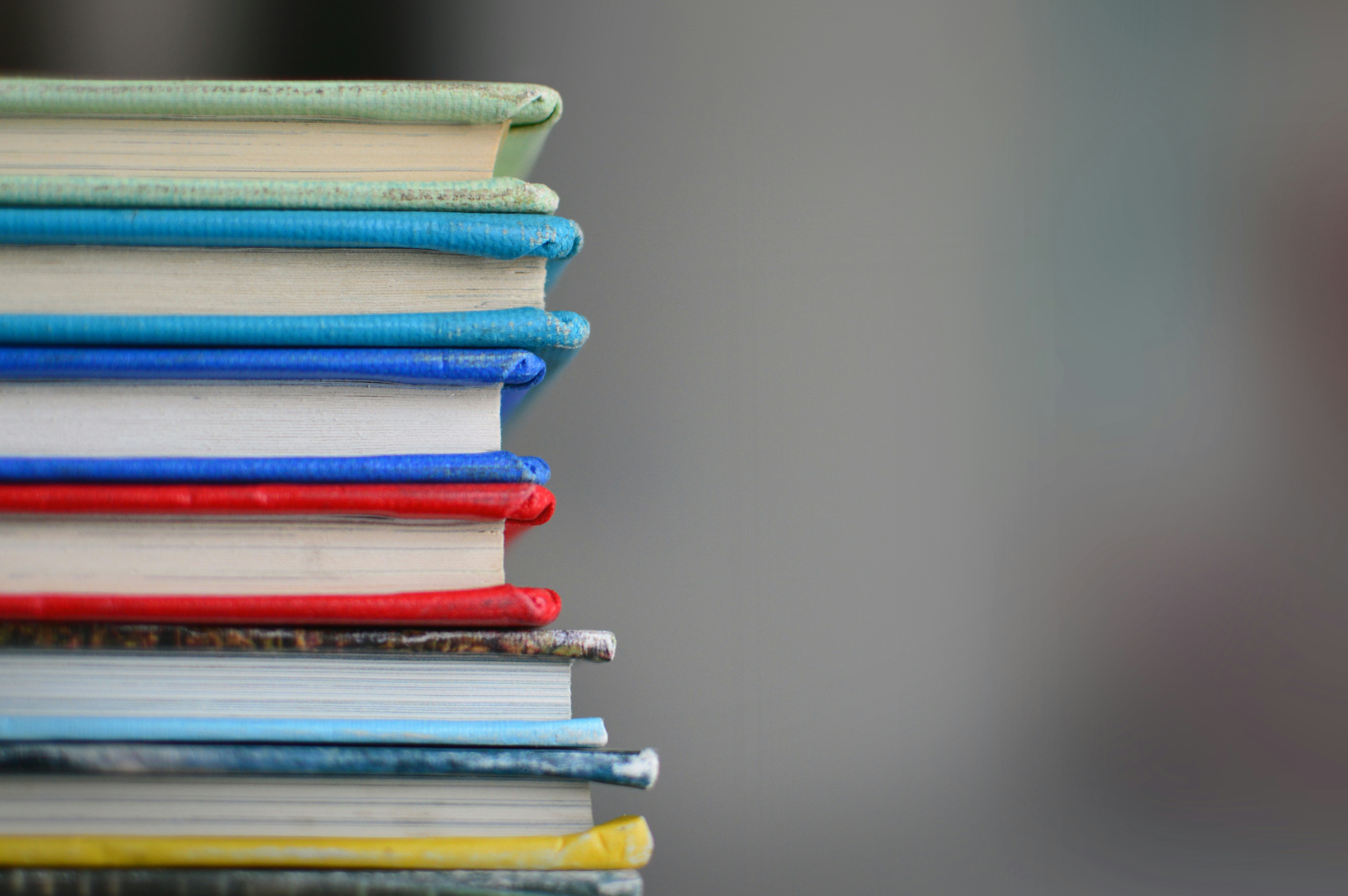 books stacked on top of eachother - Best Neuroscience Textbooks