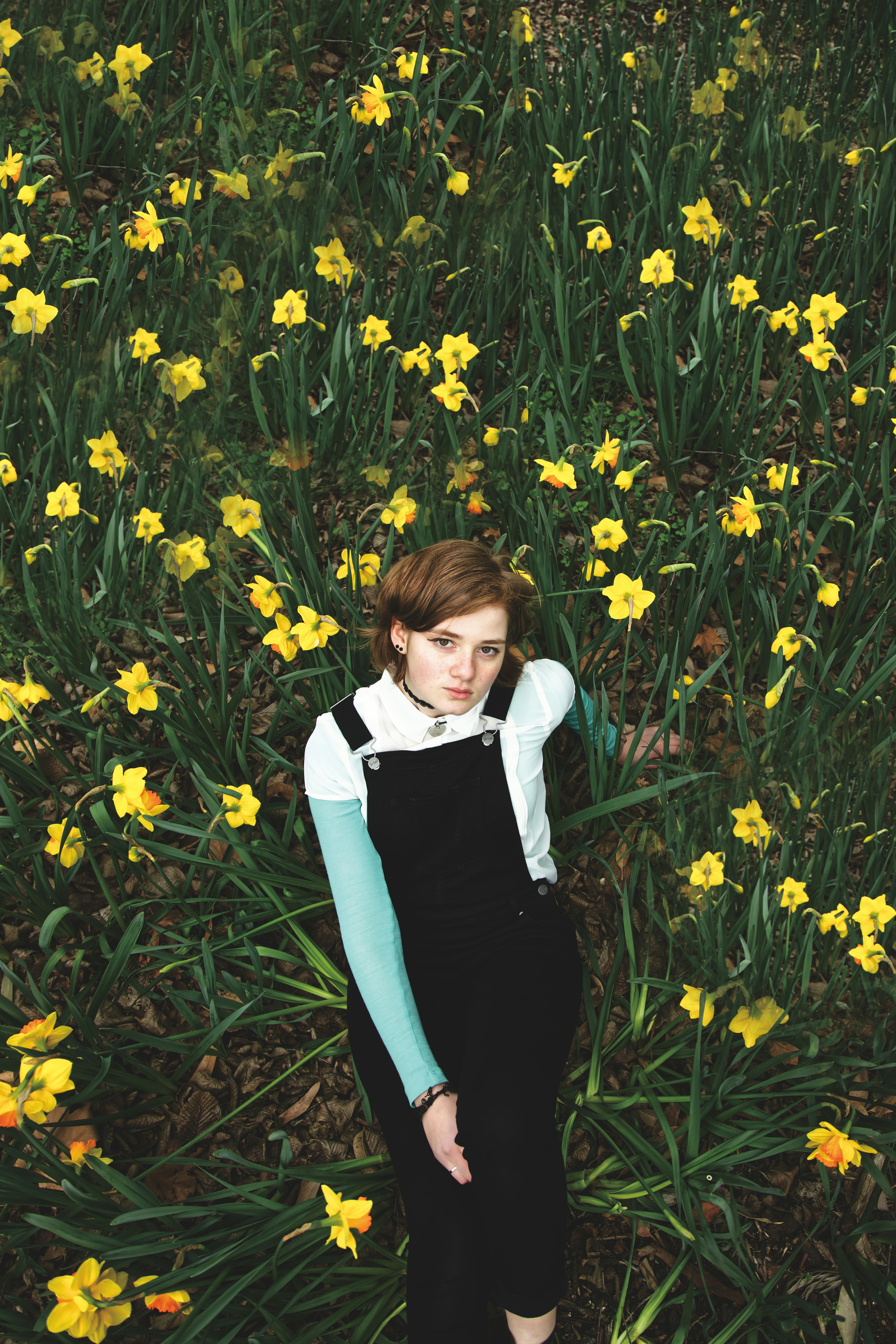 woman lying on yellow flowers