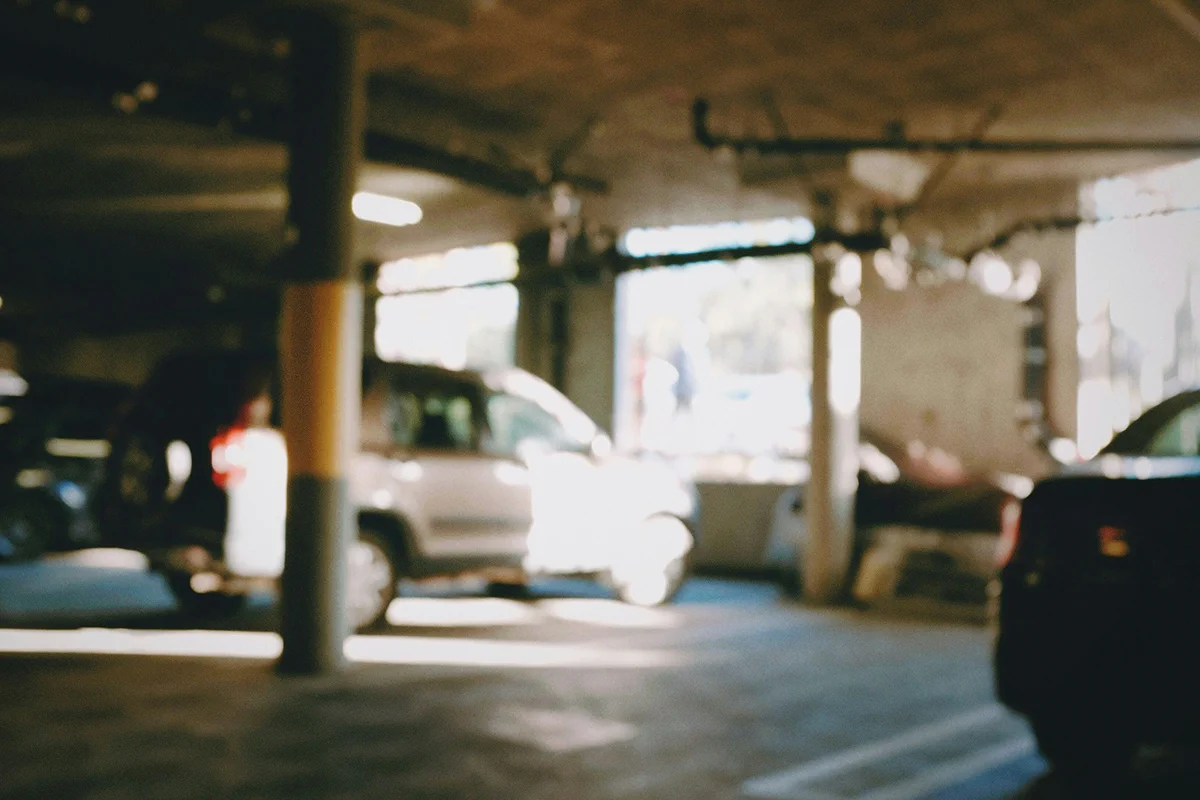 Vehicles parked inside a softly lit garage