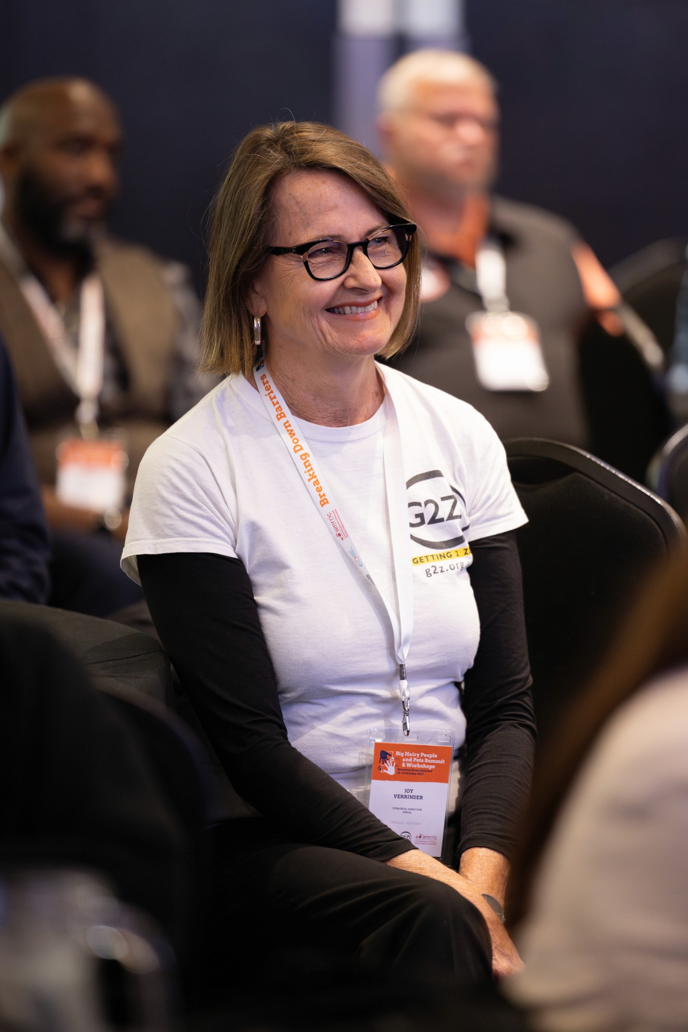 Woman smiling in audience at conference