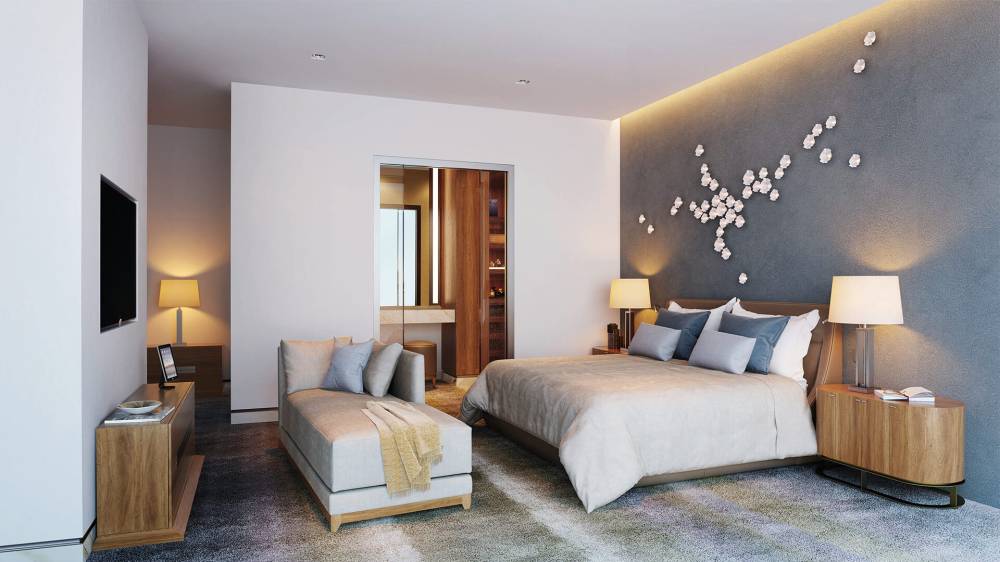 A modern bedroom featuring a large bed and a television, designed with elegance at The Royal Atlantis.