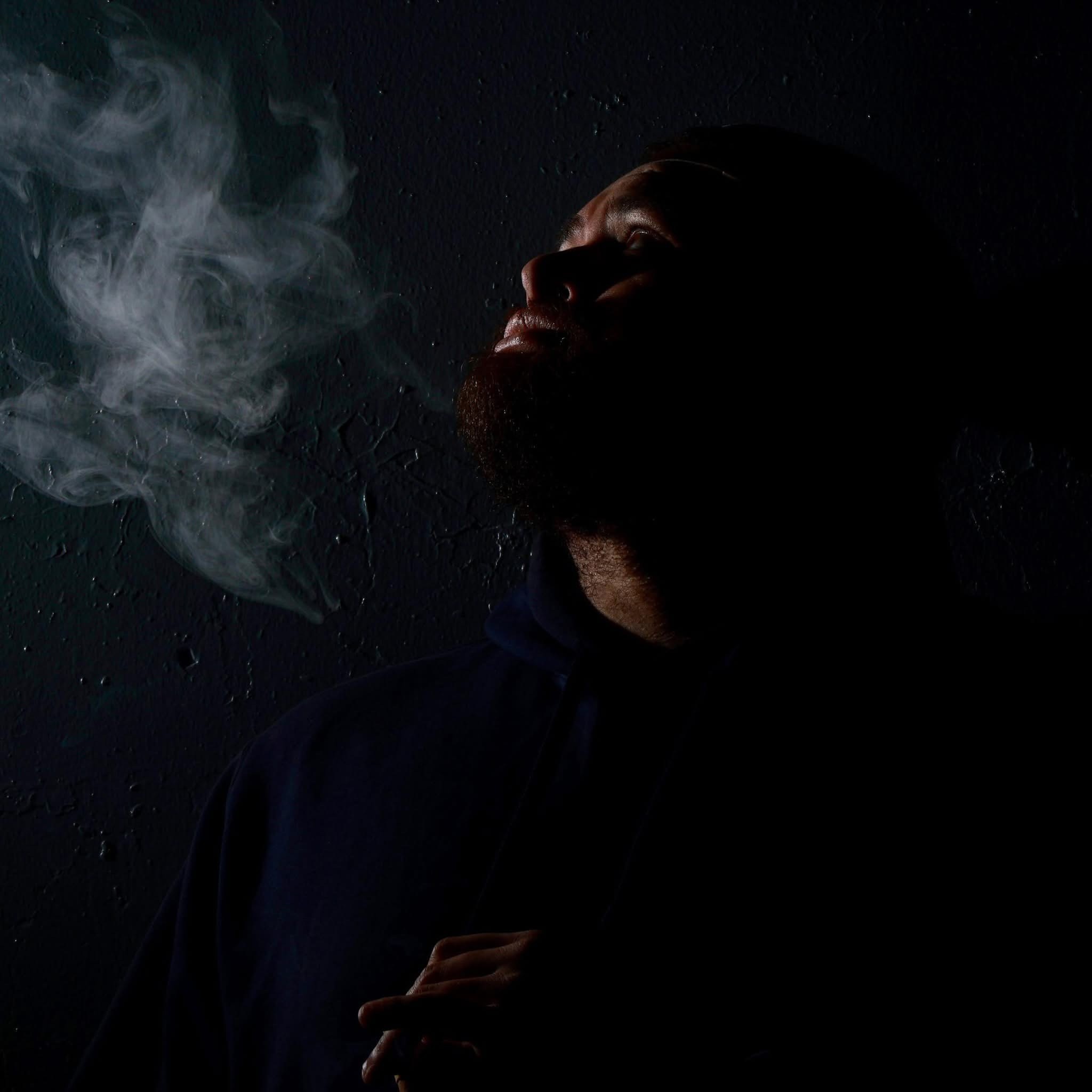 Nelson Santiago in a dark, low-key studio portrait.