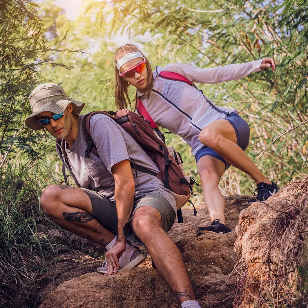 Couple hiking in a difficult trail in the hills of Colorado.