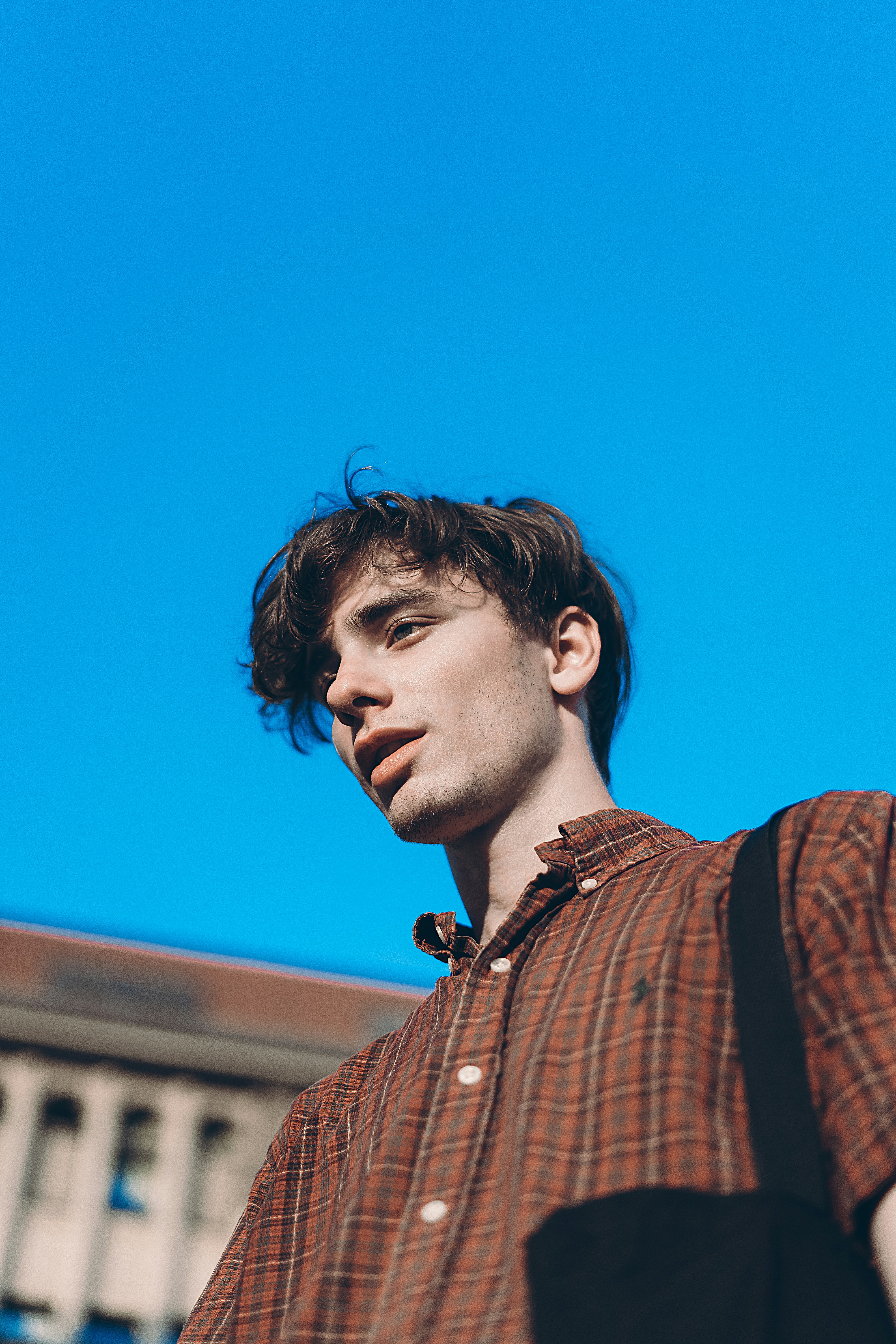low angle photo of man beside building