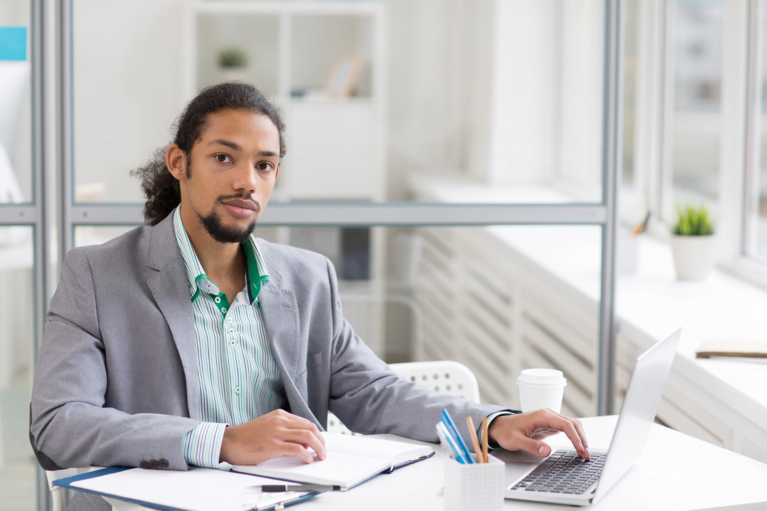 A male professional in an office setting