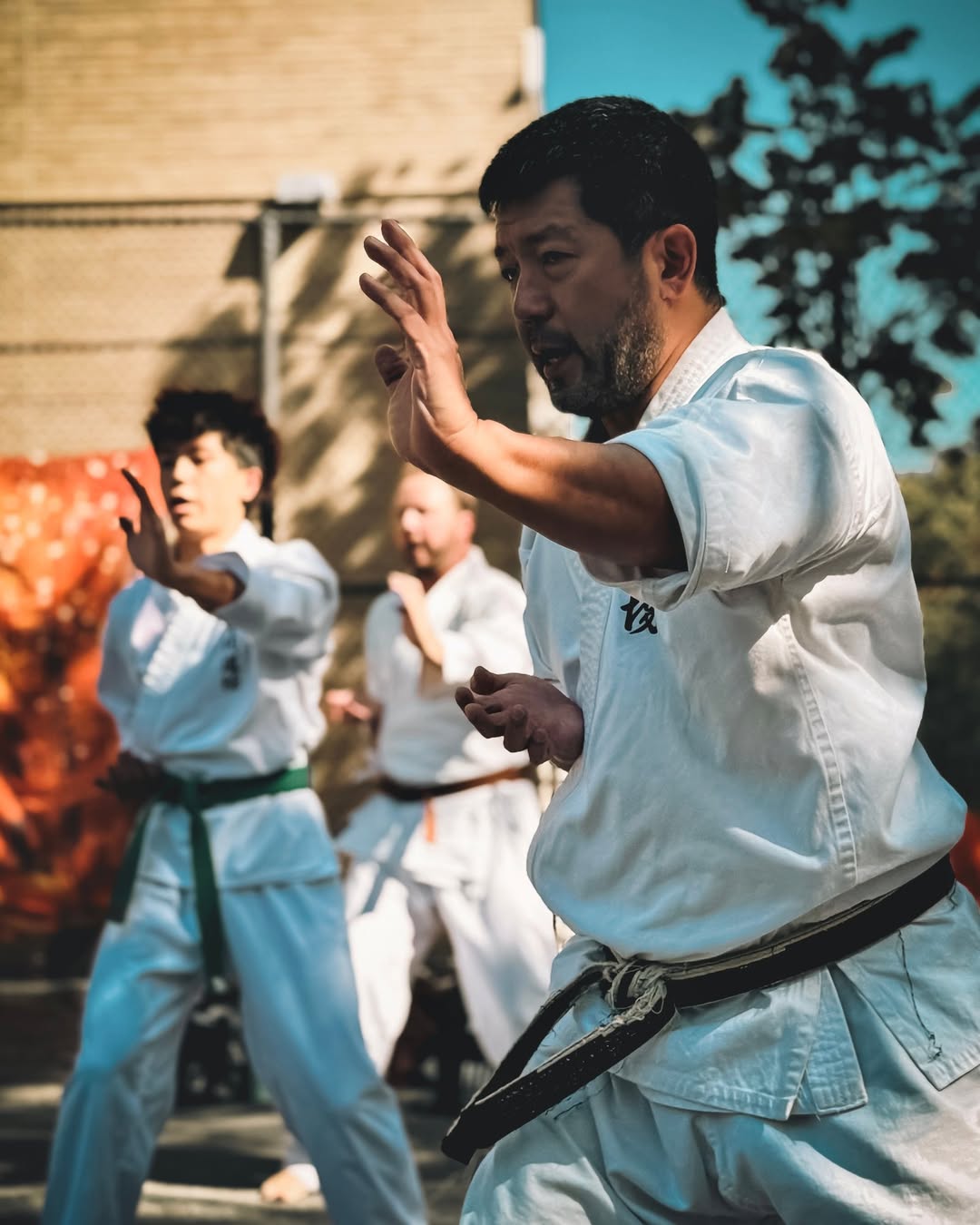 five children smiling while doing peace hand sign