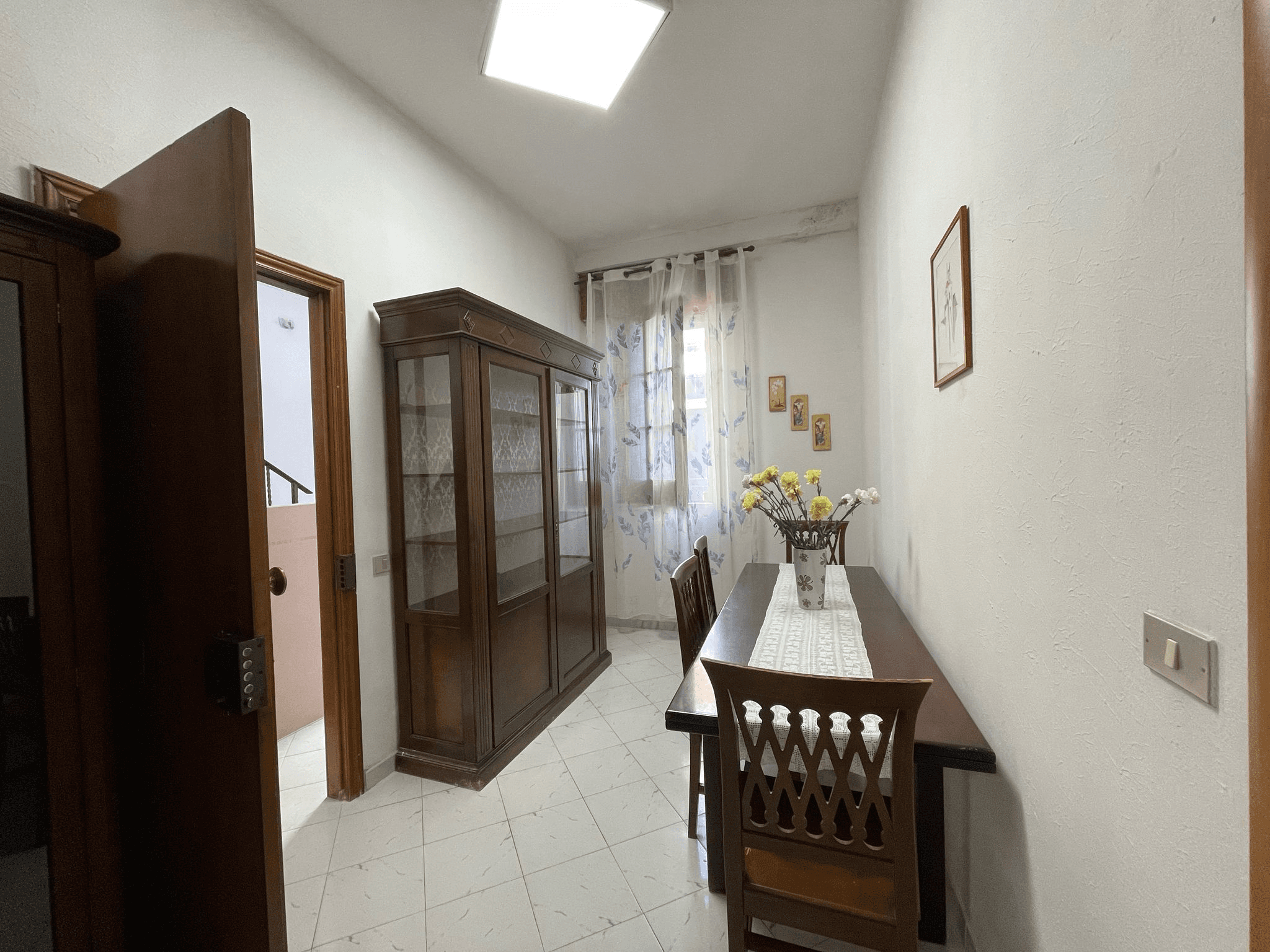 A modern brick house with a two-car garage, well-manicured lawn, and clear blue sky in the background.