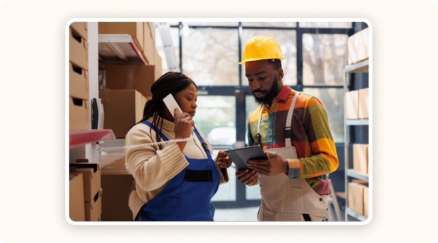 Two logistics operators in a warehouse checking inventory levels in real-time via a tablet, showing the importance of digital inventory tracking in ecommerce.