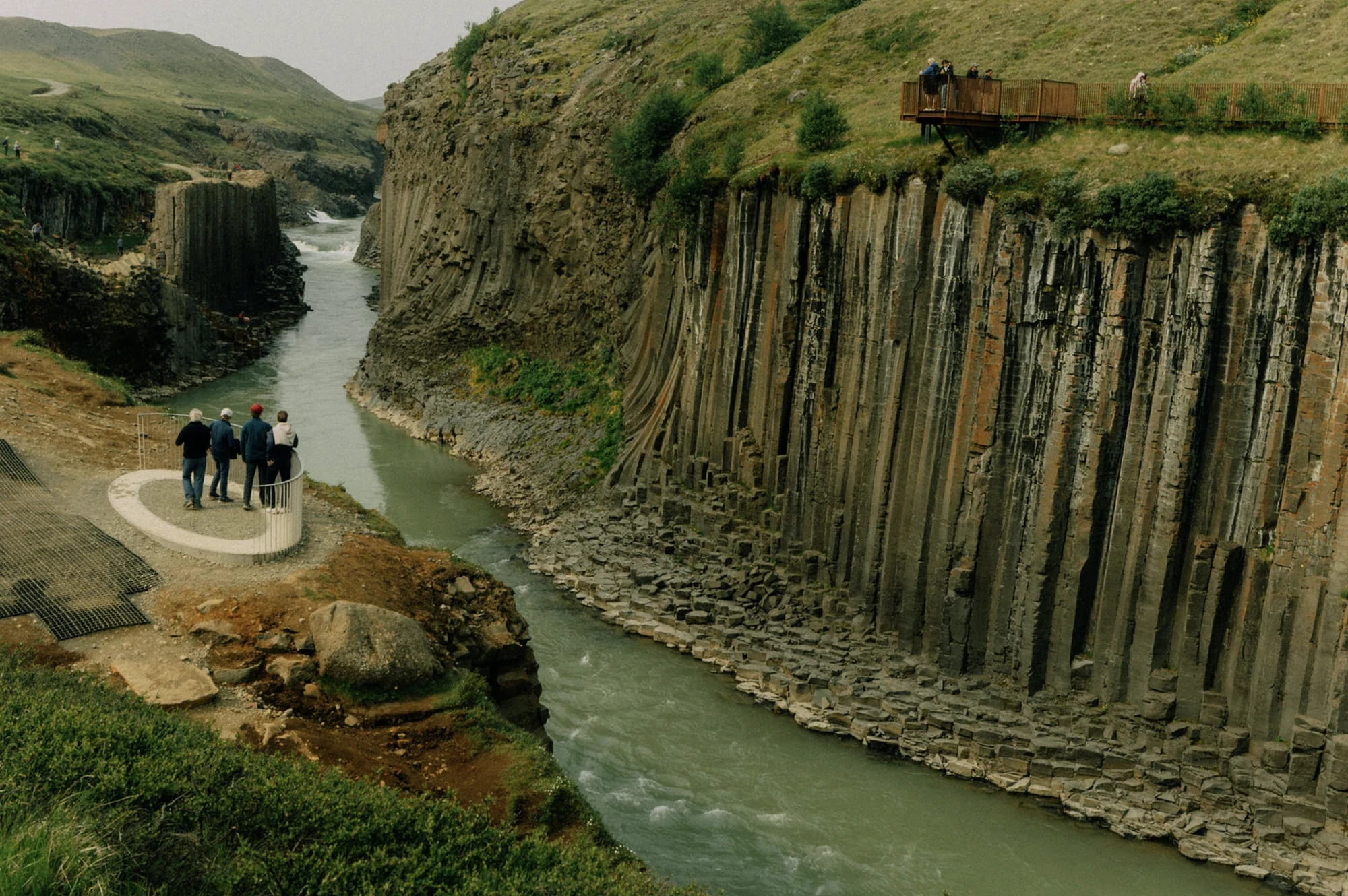 Travellers at a viewpoint above the basalt canyon of Stuðlagil in east Iceland