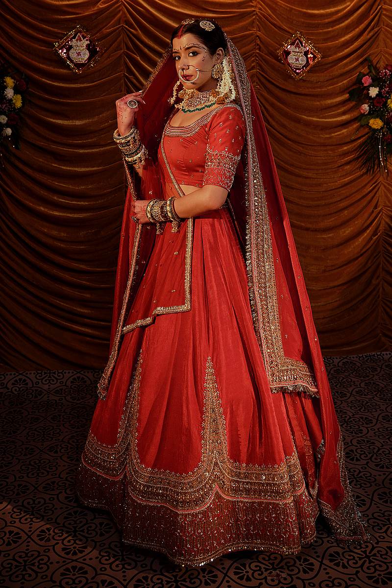 Wine velvet bridal lehenga with gold bead embroidery by Payal and Zinal
