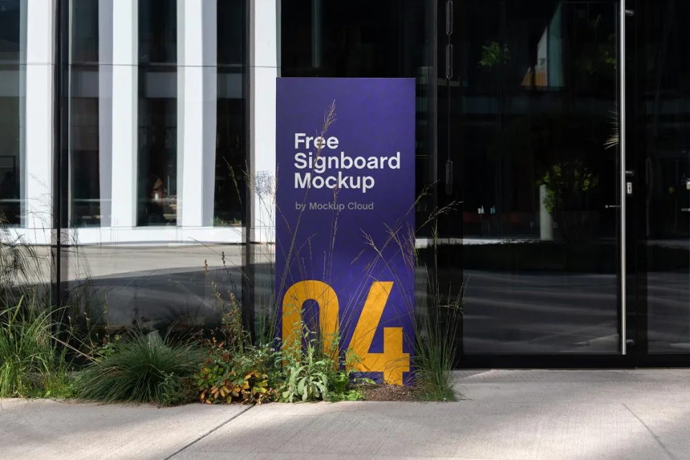 A vertical signboard mockup with a deep purple background and large yellow numerals, placed outdoors on a concrete surface surrounded by greenery. Reflective glass windows of a modern building are in the background.