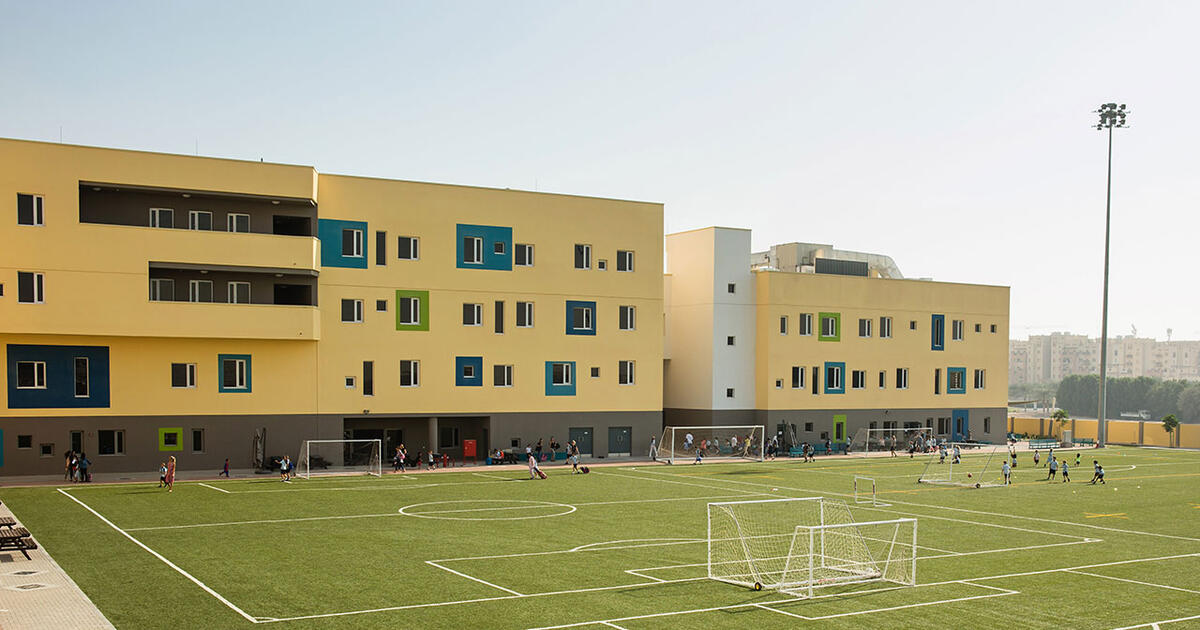 Exterior view of a Phoenix school, showcasing a contemporary design with a welcoming entrance and green surroundings.