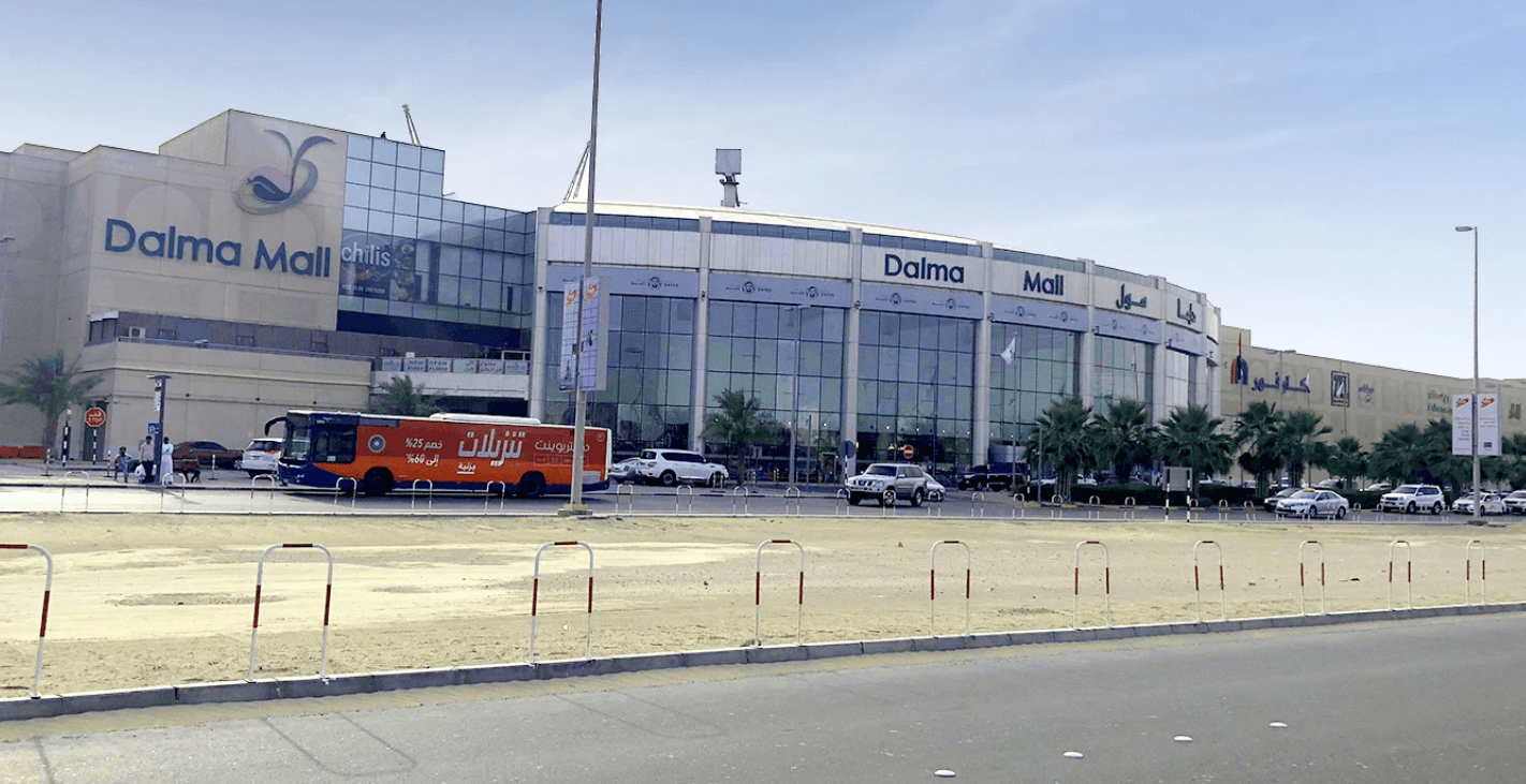 A sizable structure featuring an extensive parking lot located in Mohammed Bin Zayed City.