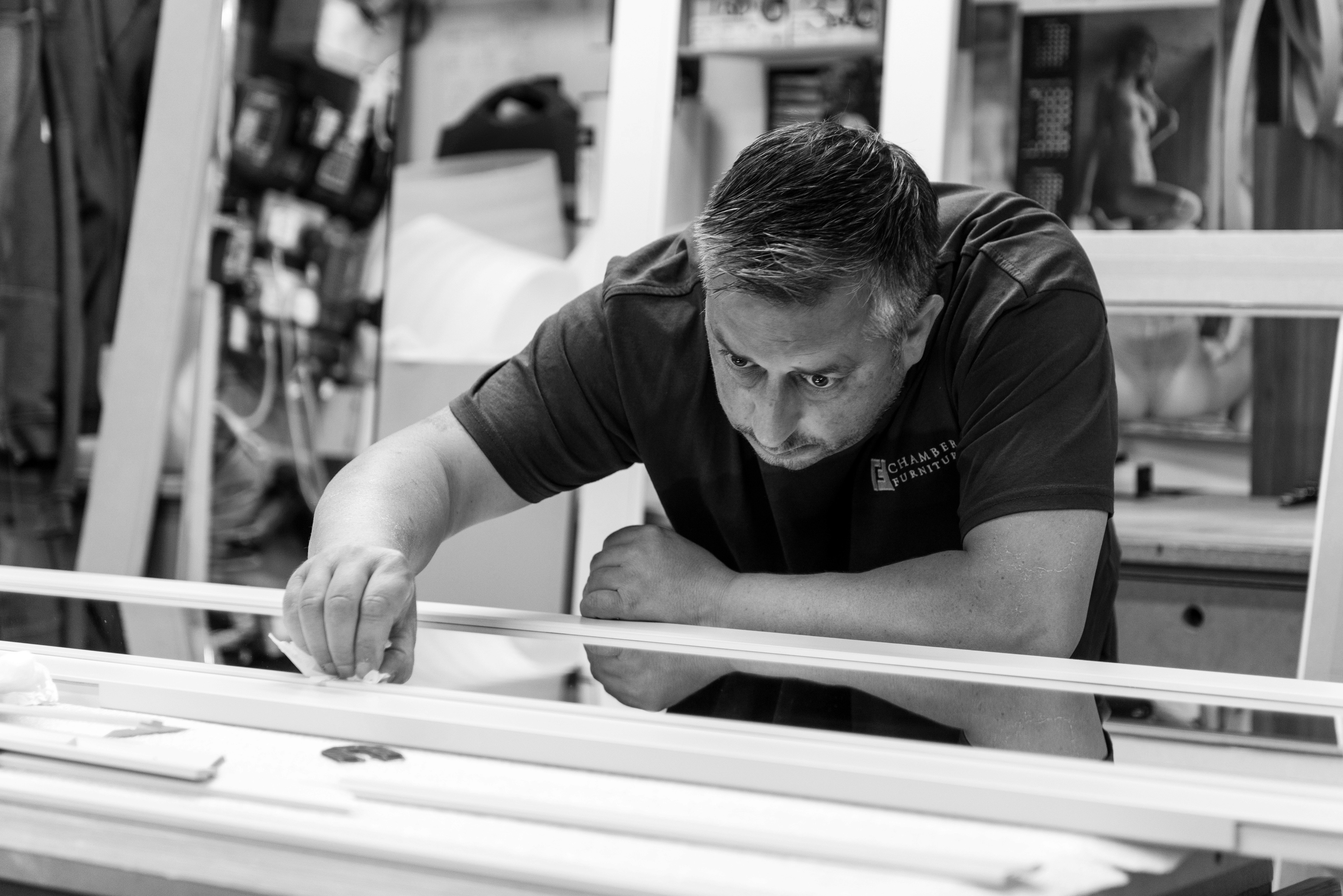 In-house manufacturing team concentrating and making precise details on furniture in our workshop