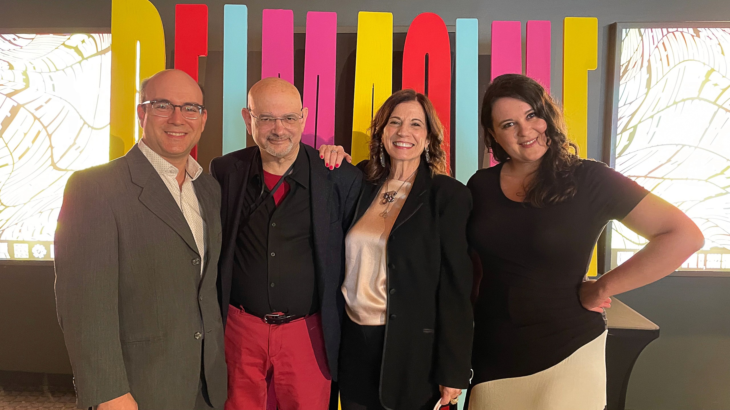 staff in front of REIMAGINE sign