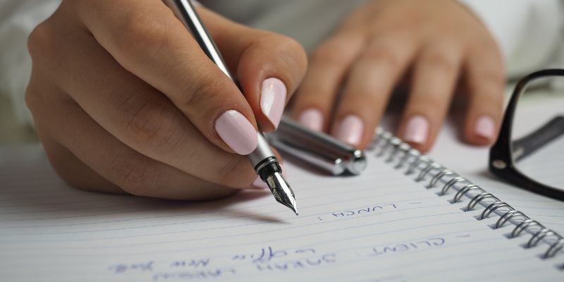 A woman writing in a notebook