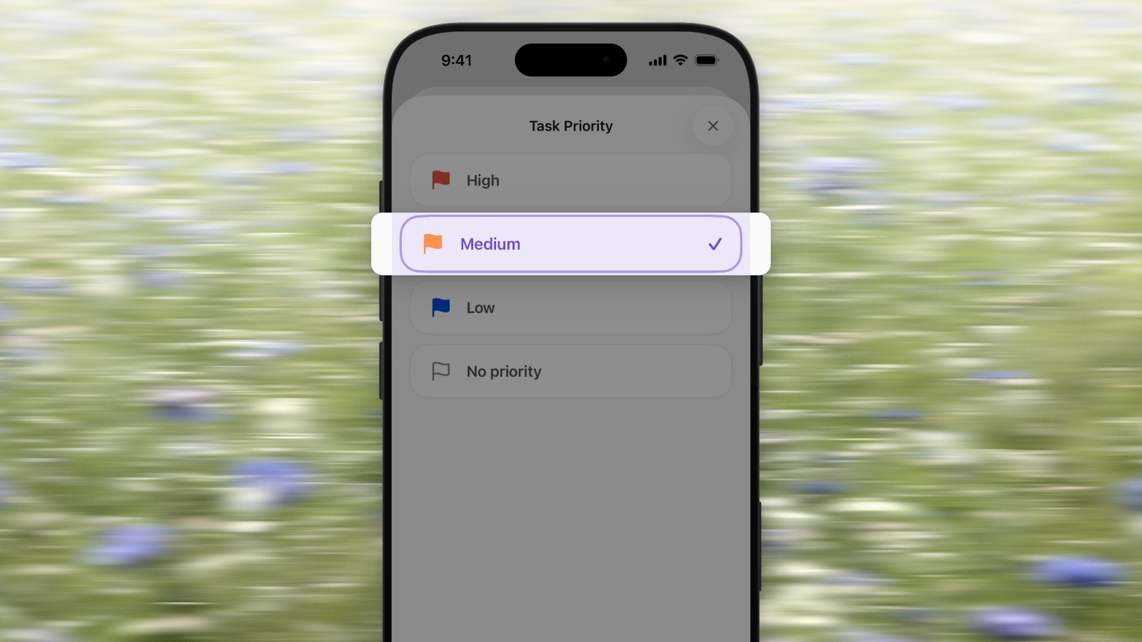The same Task Priority sheet with the Medium option lifted forward on a white card that runs past the phone’s edges, while the rest of the screen is dimmed to gray