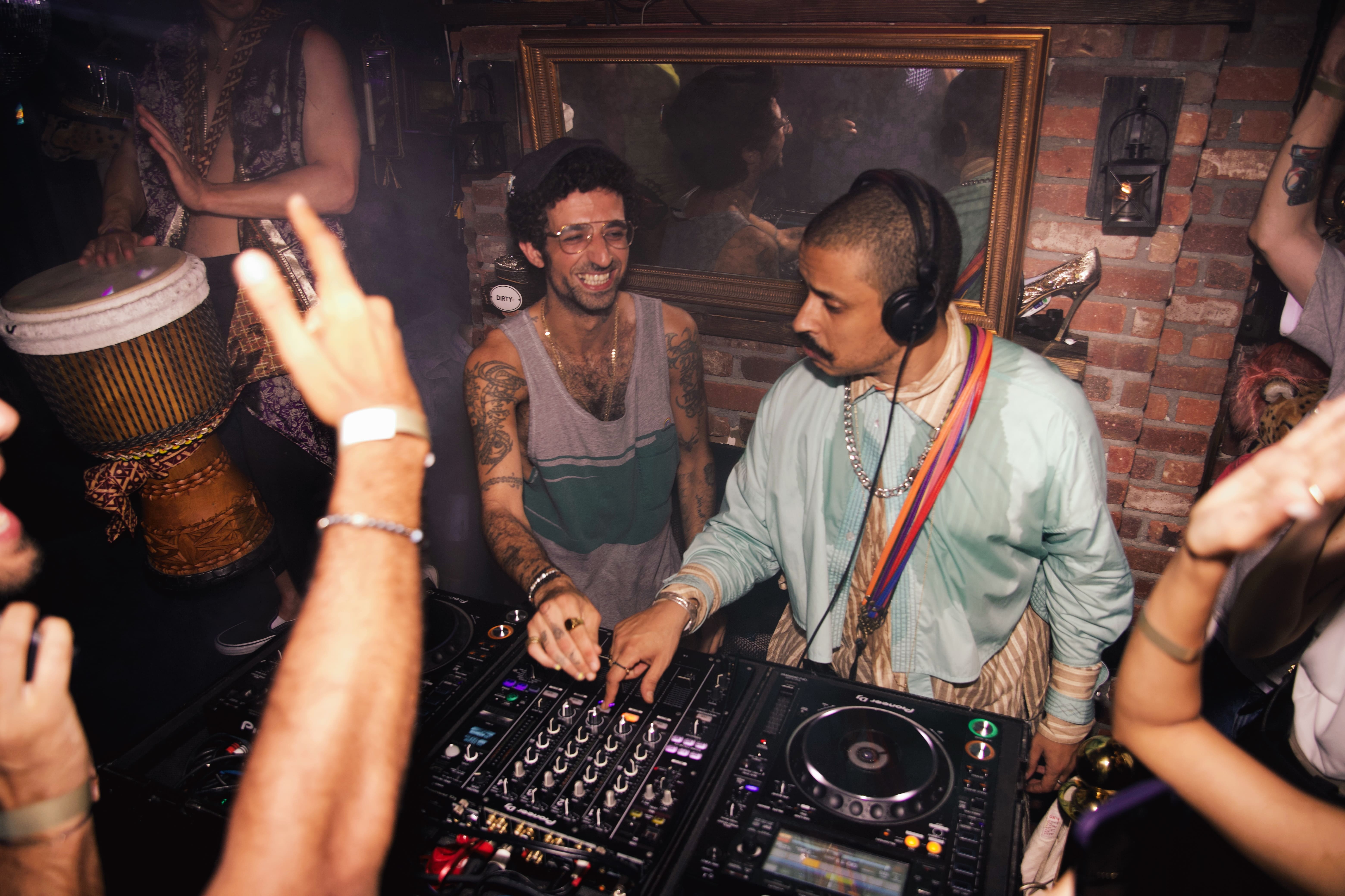 Full moon rising over a dark, silhouetted mountain ridge.