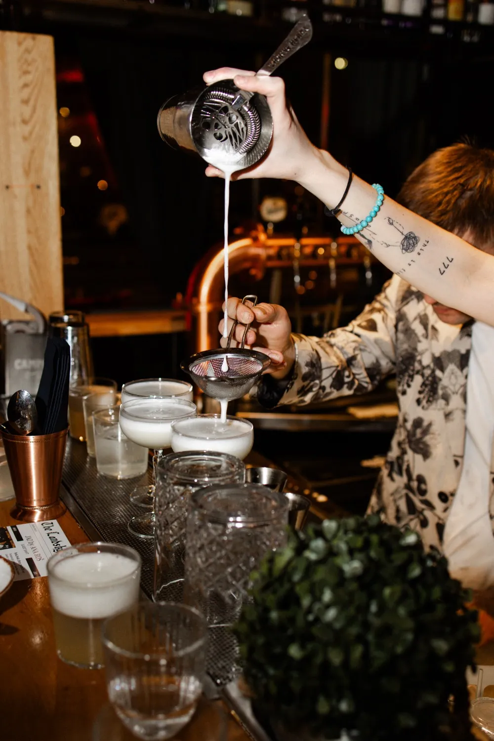 A phone, pad, and pen sit on a wooden desk.
